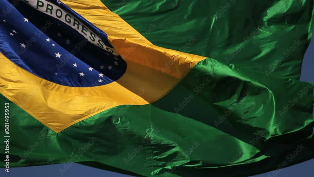 Brazilian flag blowing in the wind. Brazil, real video, blue sky