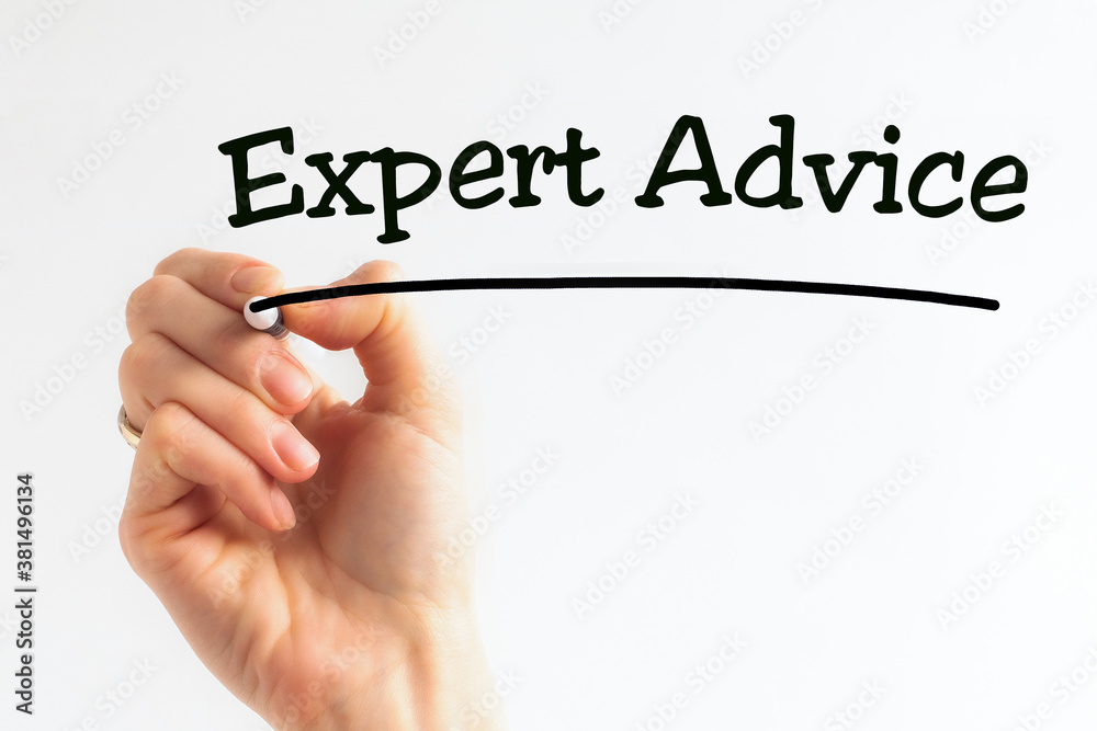 A person writes phrase Expert Advice with marker on a light background. Business concept. A person writes phrase Expert Advice with marker on a light background. Business concept.