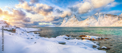 Fabulous winter view of Vik beach during sunset with lots of snow and snowy mountain peaks near Leknes.