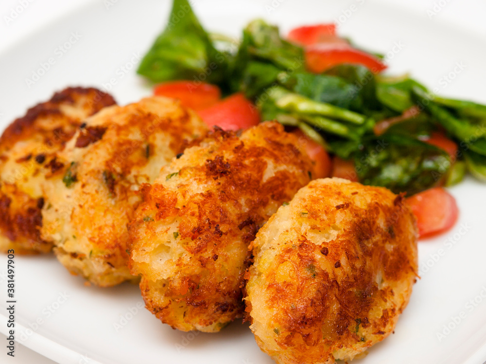 Pasteis de bacalhau - portuguese cod fritters with salad Pasteis de bacalhau - portuguese cod fritters with salad