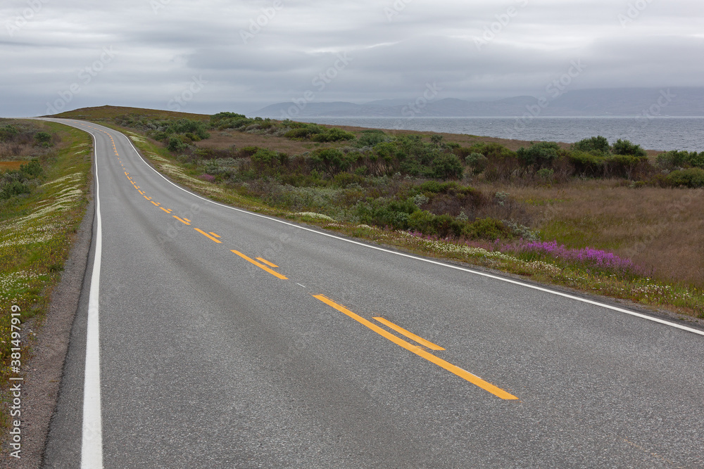 The twisting road along the coast of the Barents Sea, Varanger national scenic route in Finnmark, Norway