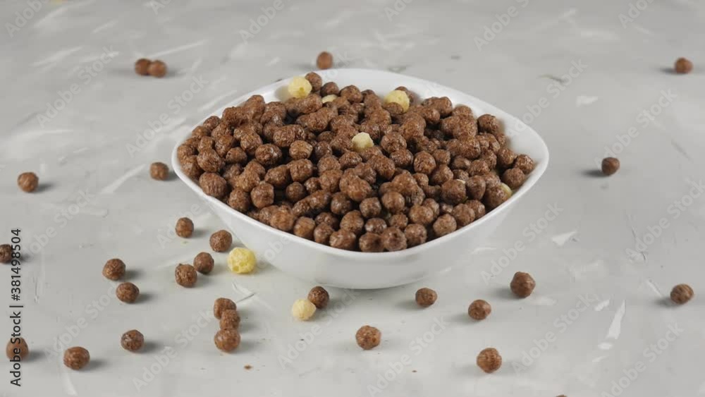 Chocolate Flakes. Flakes with milk for breakfast. Full teralka of chocolate flakes. Healthy breakfast. Flakes pour into a plate Chocolate Flakes. Flakes with milk for breakfast. Full teralka of chocolate flakes. Healthy breakfast. Flakes pour into a plate