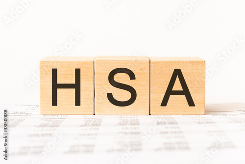 Word hsa. Wooden small cubes with letters isolated on white background with copy space available.Business Concept image.