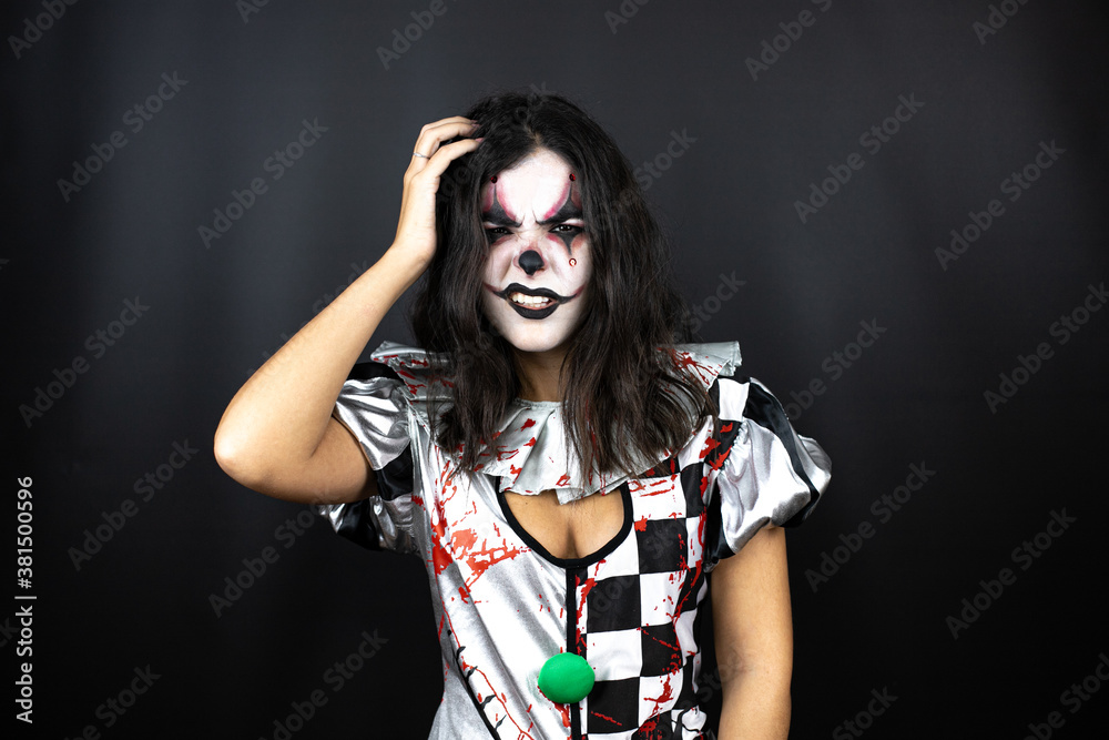 woman in a halloween clown costume over isolated black background confuse and wonder about question. Uncertain with doubt, thinking with hand on head woman in a halloween clown costume over isolated black background confuse and wonder about question. Uncertain with doubt, thinking with hand on head