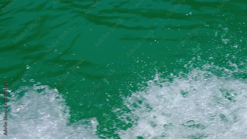 Slow motion clear transparent water waves splashing from boat ride Slow motion clear transparent water waves splashing from boat ride