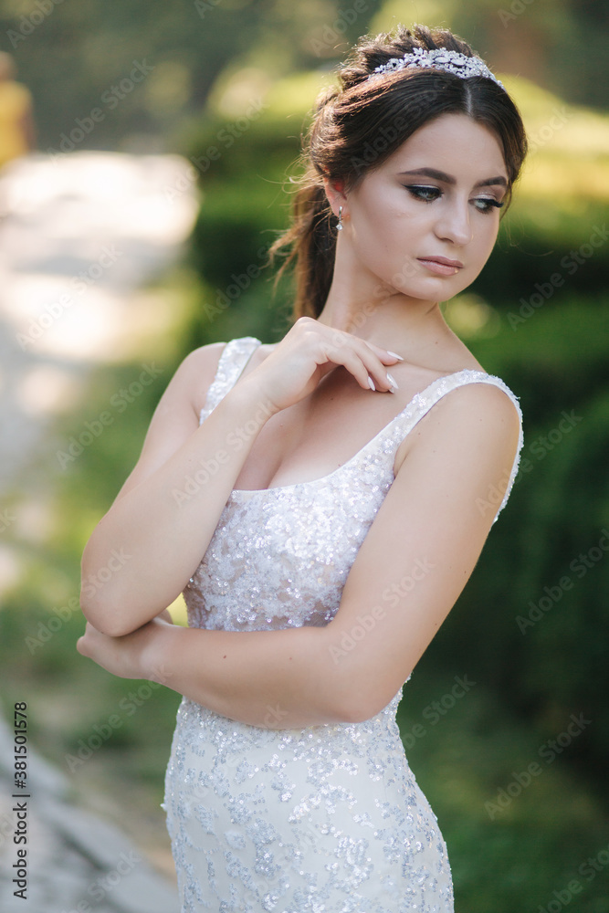 Portrait of young bride in white wedding dress outdoors. Fashion makeup Portrait of young bride in white wedding dress outdoors. Fashion makeup