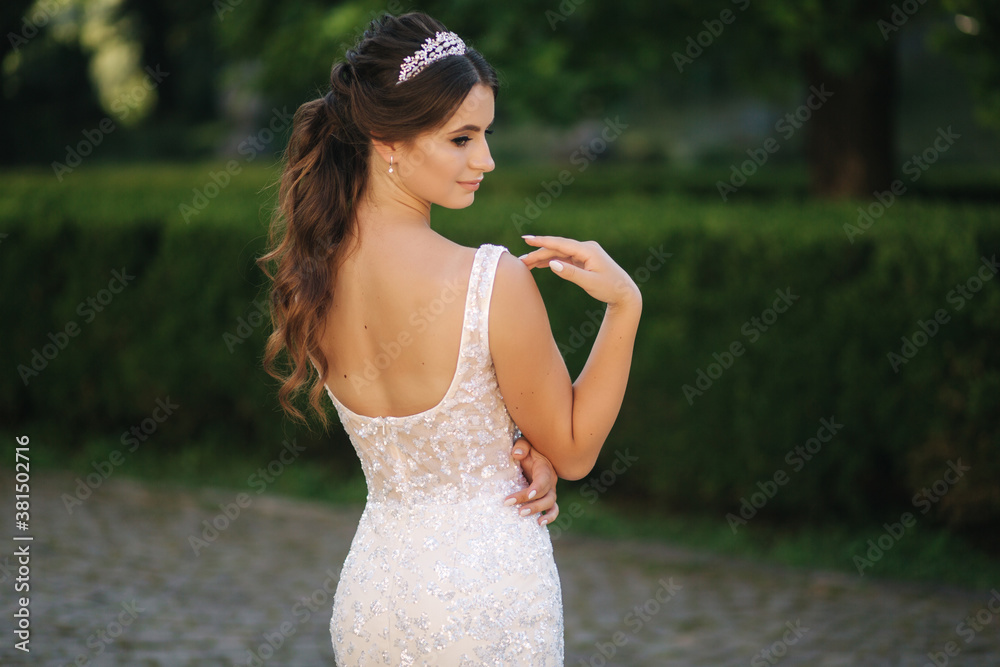 Naklejka premium Portrait of young bride in white wedding dress outdoors. Fashion makeup