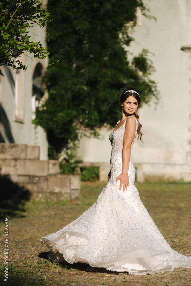 Young female model in wedding dress outdoors. Fashion photo of bride Young female model in wedding dress outdoors. Fashion photo of bride