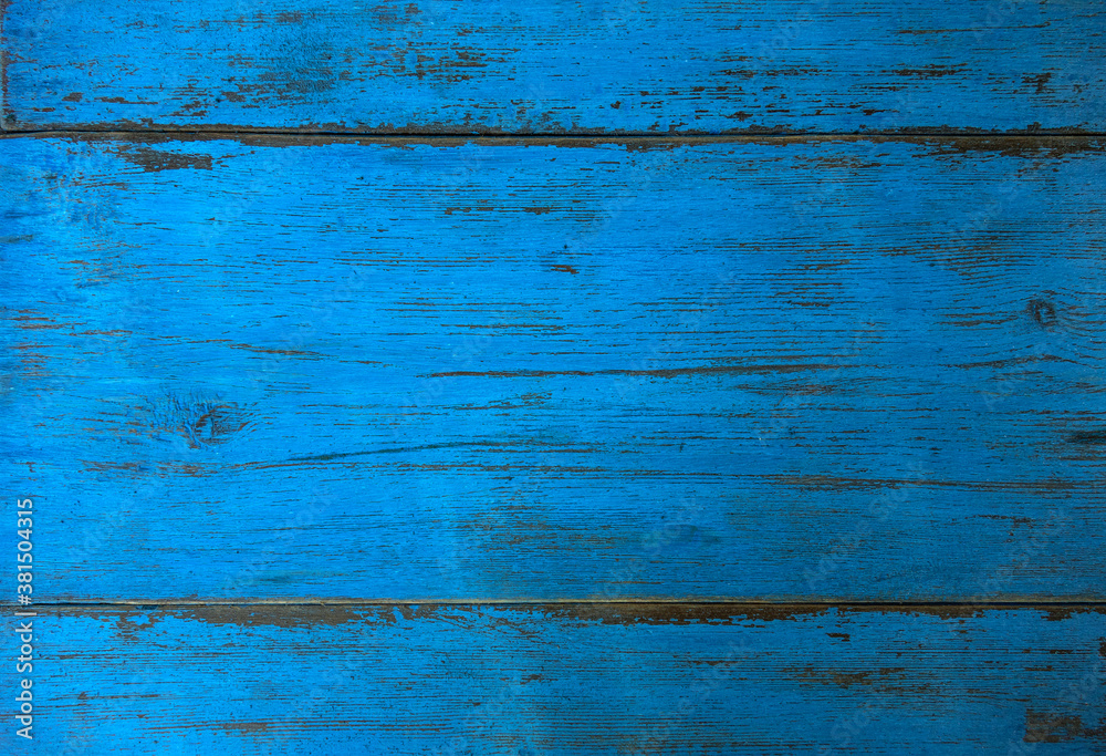 Obraz premium The texture of the wood surface is blue with cracks
