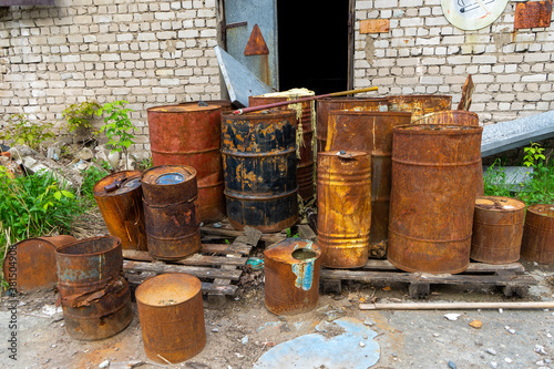 A rusty barrel with a chemical waste leak. Chemical disposal