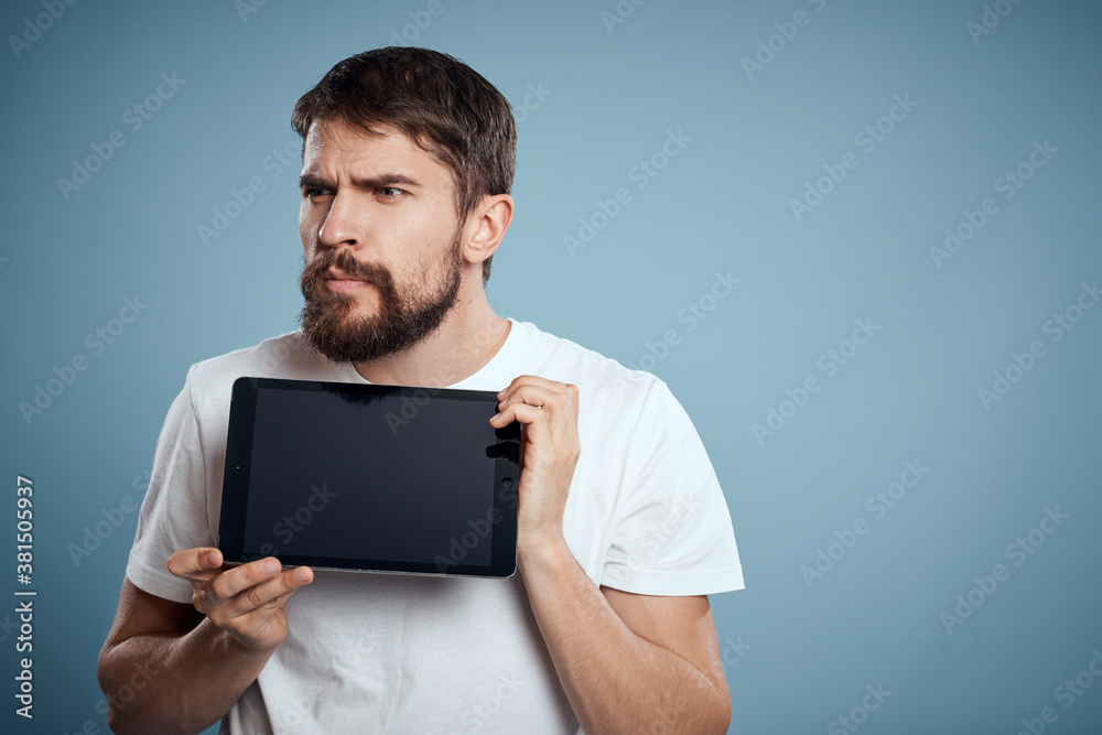 man with touch tablet in hands on blue background gesturing with hands cropped view copy space emotions model man with touch tablet in hands on blue background gesturing with hands cropped view copy space emotions model