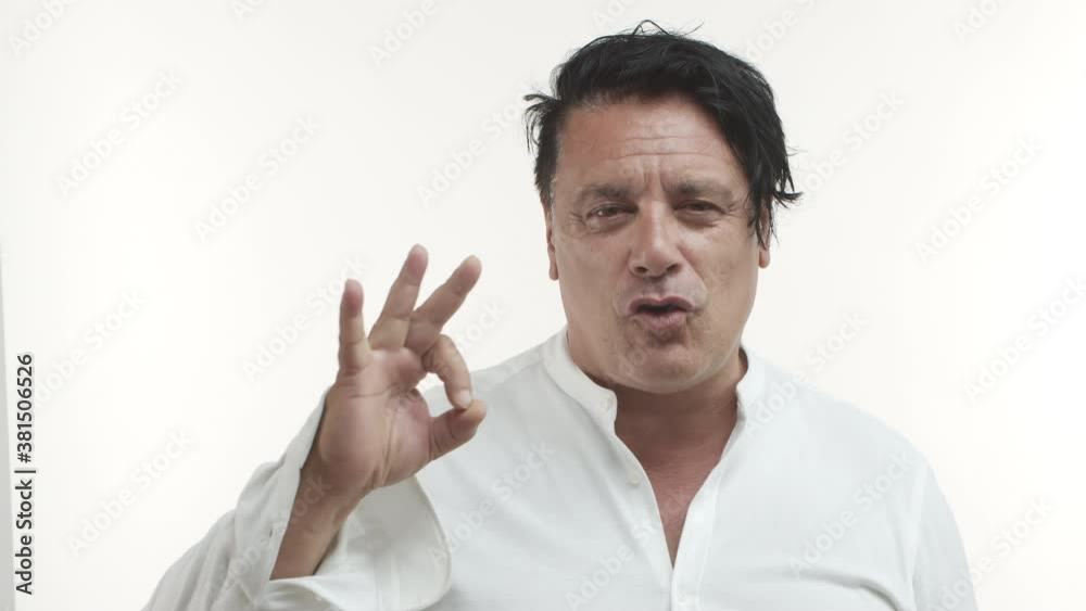 Close-up of middle-aged chubby italian guy in white casual t-shirt recommend something very good, guarantee quality and showing okay sign, standing over white background