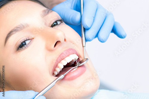 Dentist and patient in the dental office. Woman having teeth examined by dentists