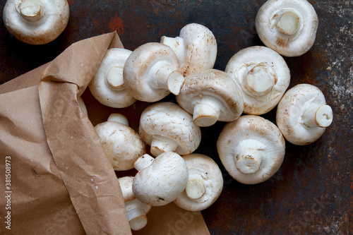 Fresh champignons in a craft paper bag