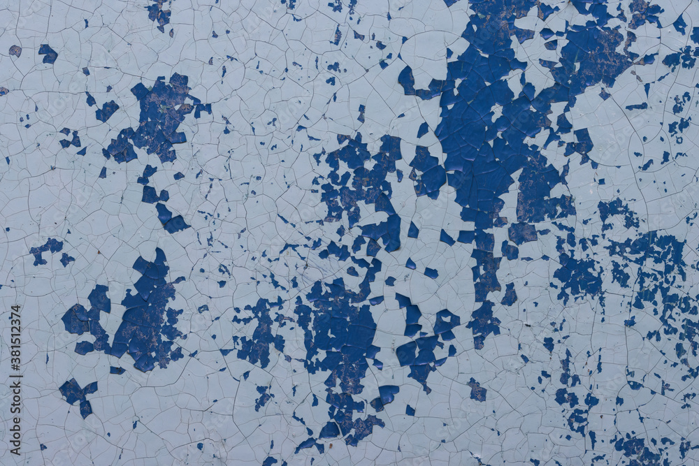 Blue peeling paint on the wall. Old concrete wall with cracked flaking paint. Weathered rough painted surface with patterns of cracks and peeling. High resolution texture for background and design. Blue peeling paint on the wall. Old concrete wall with cracked flaking paint. Weathered rough painted surface with patterns of cracks and peeling. High resolution texture for background and design.