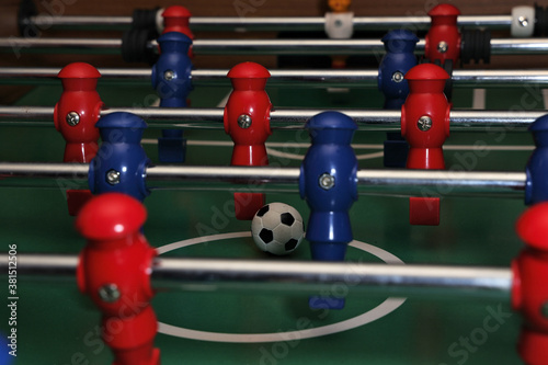 Foosball field level with red and blue players and ball © Shauna