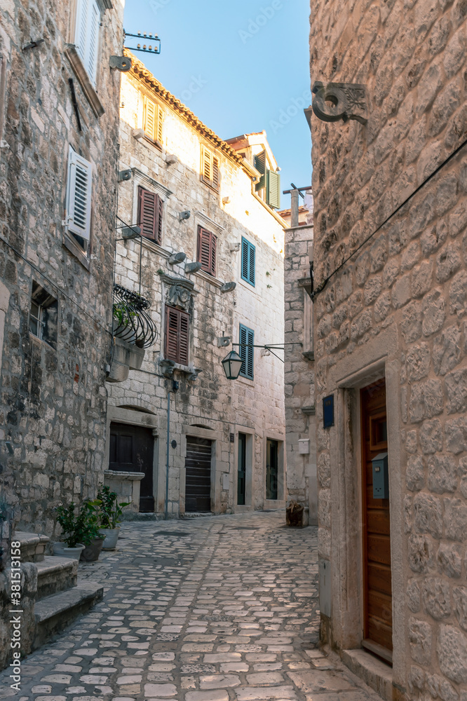 Narrow cobbled street in the town of Hvar, Adriatic coast, Croatia.