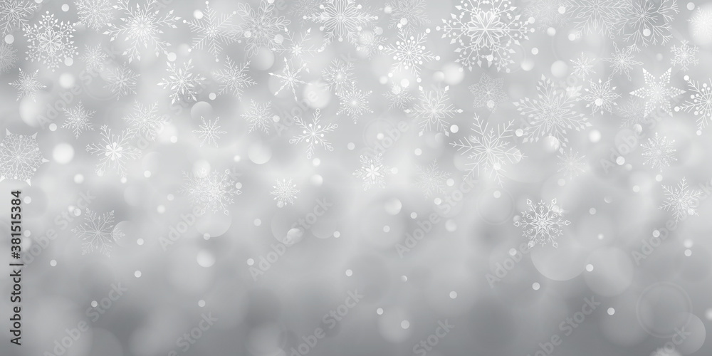 Christmas background of complex big and small falling snowflakes in gray colors with bokeh effect