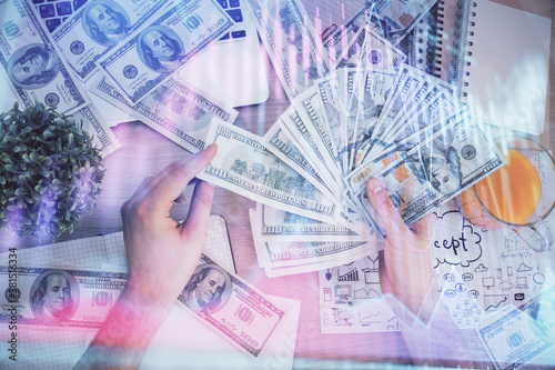 Multi exposure of financial graph drawing hologram and USA dollars bills and man hands. Analysis concept.