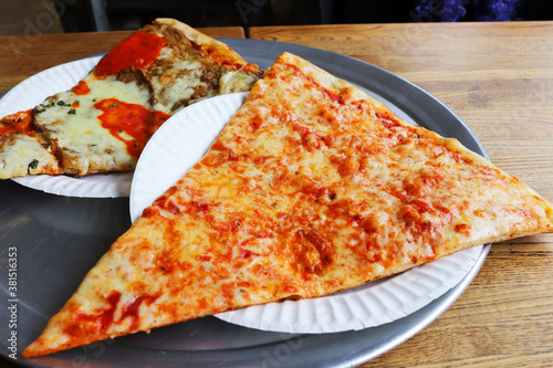 Two slices of New York thin crust cheese pizza