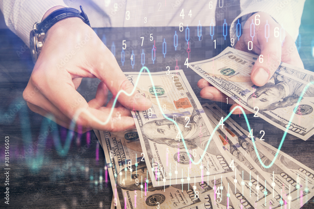 Multi exposure of financial graph drawing hologram and USA dollars bills and man hands. Analysis concept. Multi exposure of financial graph drawing hologram and USA dollars bills and man hands. Analysis concept.