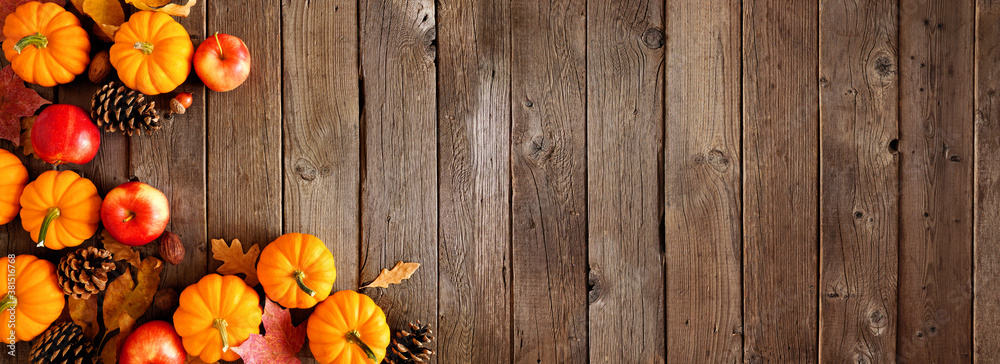 Autumn corner border with pumpkins, leaves and apples. Top down view on a rustic dark wood background with copy space. - obrazy, fototapety, plakaty 