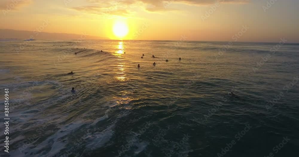 Group of surfers float off Hawaiian coastline, wide aerial Group of surfers float off Hawaiian coastline, wide aerial