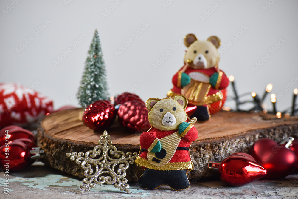 Christmas decoration: felt bears, musicians, stars, pine cones, Christmas tree, lights. Rustic wood background