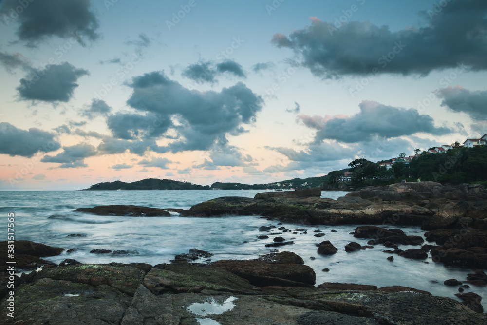 Peaceful landscape of a dreamy sunset at Bombinhas beach, Brazil, with the seawater on a silk effect and cottony clouds in the sky. Peaceful landscape of a dreamy sunset at Bombinhas beach, Brazil, with the seawater on a silk effect and cottony clouds in the sky.
