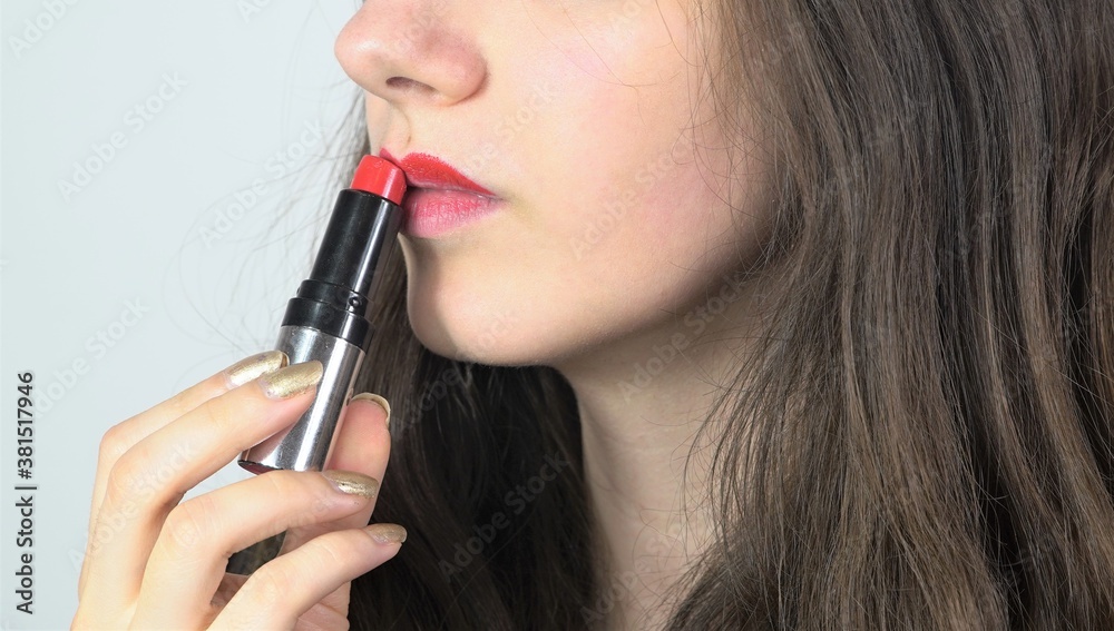 pretty women using red lipstick - close up