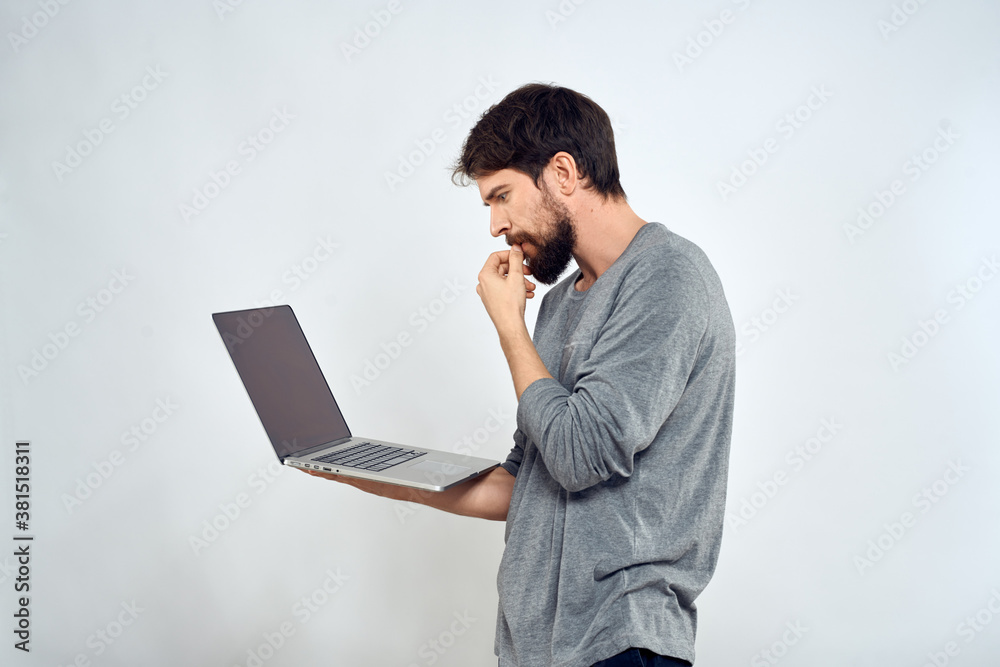 Bearded man with laptop in hands internet communication technology light background Bearded man with laptop in hands internet communication technology light background