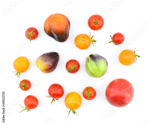 Top view of various tomatoes isolated on white background. Healthy vegetarian food concept.