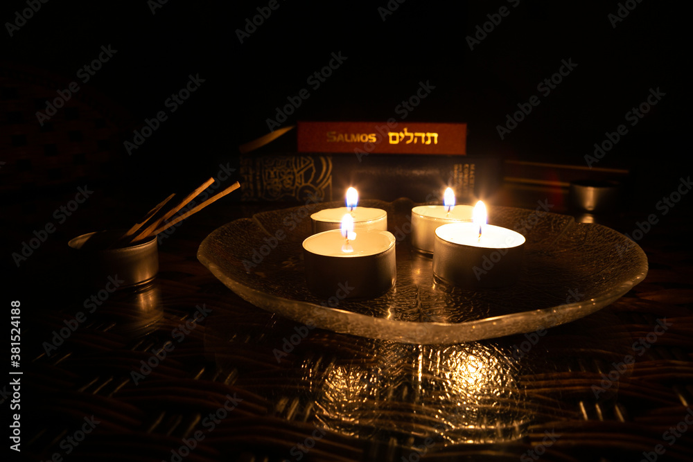 Candles lit on the day of Yom Kippur with the book of Psalms and the