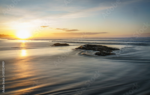 Sunrise rocky beach coast scene