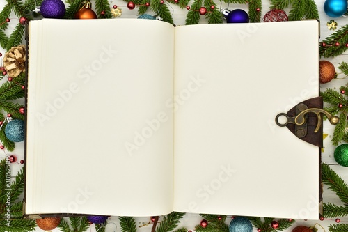New year 2021, Christmas. Knitted colored numbers, fir branches and Christmas decorations on a white wooden background. Texture, design, decor, amigurumi, creativity, hobby, greeting card, handmade.