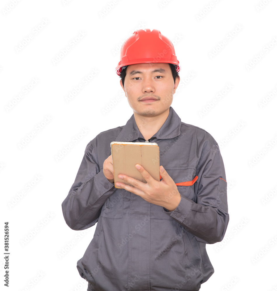 Construction worker with red hard hat holding ipad in hand standing in front of white background Construction worker with red hard hat holding ipad in hand standing in front of white background