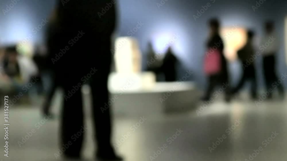 View of people walking during an art gallery exhibition visit. Background with an intentional blur effect applie. 4K View of people walking during an art gallery exhibition visit. Background with an intentional blur effect applie. 4K