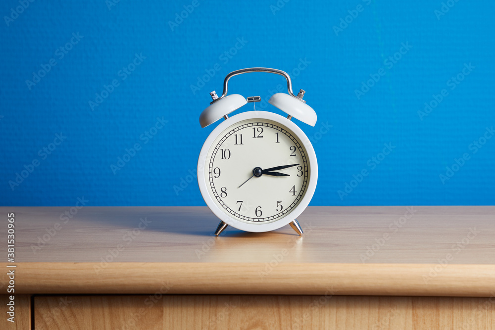 Alarm clock in a room, blue wall Alarm clock in a room, blue wall