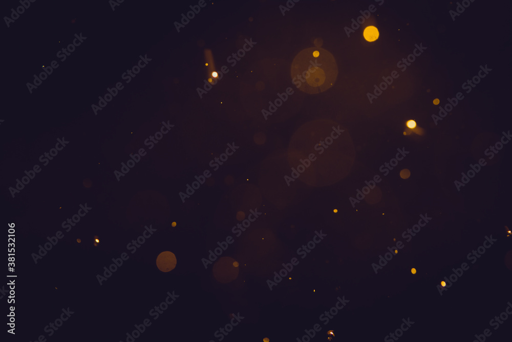 Dark Abstract Gold bokeh sparkle on black background