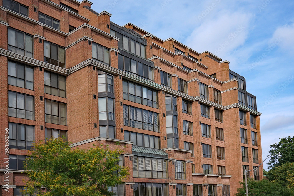 Exterior of mid-rise yellow brick apartment building