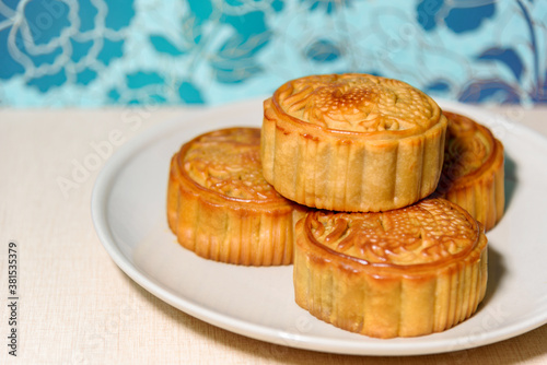 Chinese food Mooncakes on plate. Chinese bakery product traditionally eaten during the Mid-Autumn Festival. 