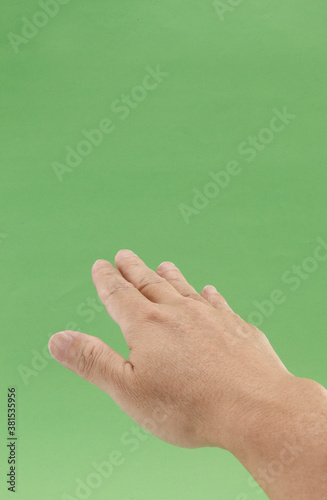 hand of person on green background.