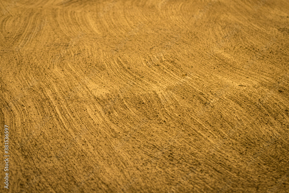 Fototapeta premium Gold wall treated with textured Rough plaster