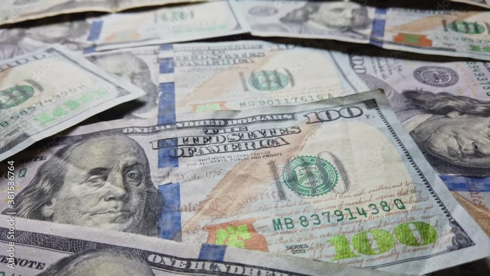 Hundred dollar benjamin franklin bills slow pan across money.  Business and financial concepts for abundance and American US dollar federal reserve.  Colorful moving money background. Economics.