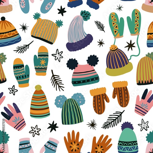 Cute vector seamless pattern of winter clothing, hats, mittens and gloves. Freehand drawn doodle elements. 