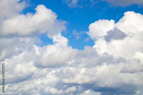 Natural background. Blue sky with white clouds. Many white clouds on a sunny day.