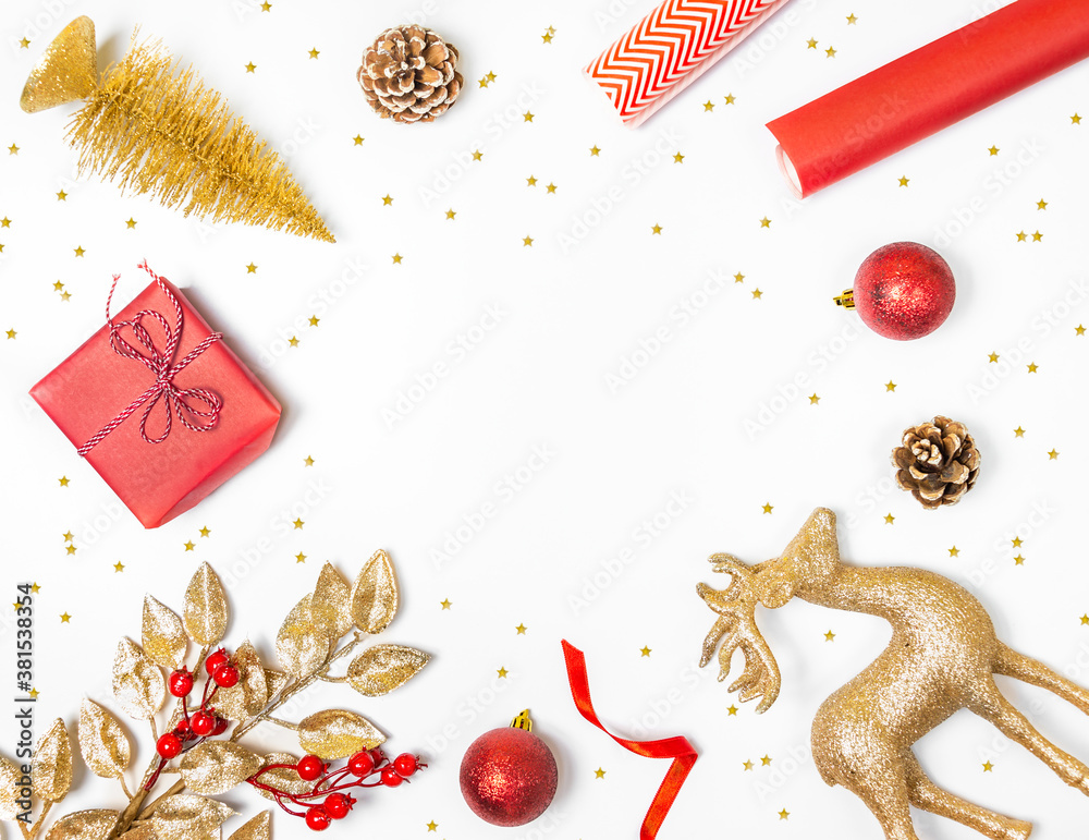Christmas background - gift box, mistletoe, fircones,reindeer and christmas balls in golden and red colors over white background.