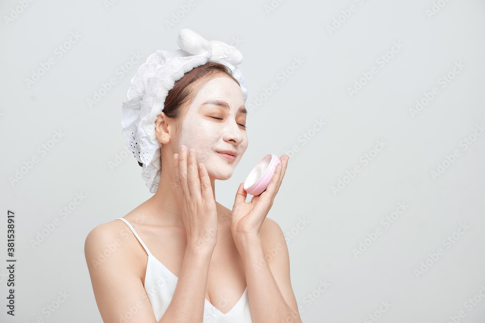 Spa Asian woman applying facial clay mask. Spa beauty concept. Spa Asian woman applying facial clay mask. Spa beauty concept.
