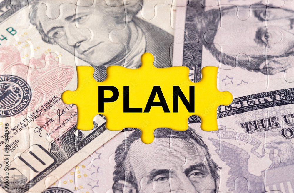 Fototapeta premium Puzzle with the image of dollars in the center of the inscription -PLAN