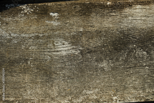 Wooden plank left outside heavy weathered silver grey brown tones - closeup overlay. Fence board, lumber, timber, rouh sawn, background, surface, barnwood photo